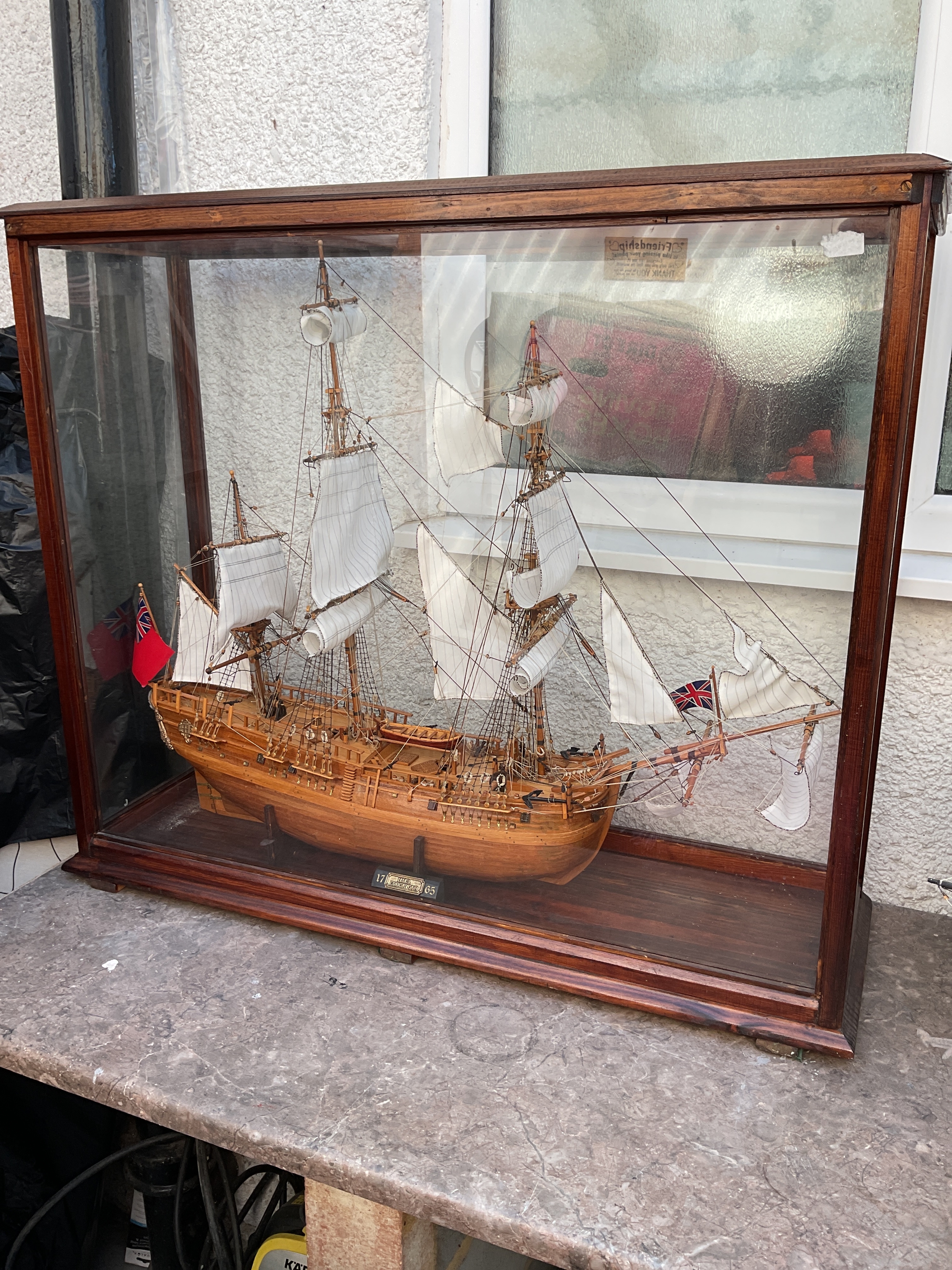 Cased model of 1765 HMS Endeavour with colours flying.
