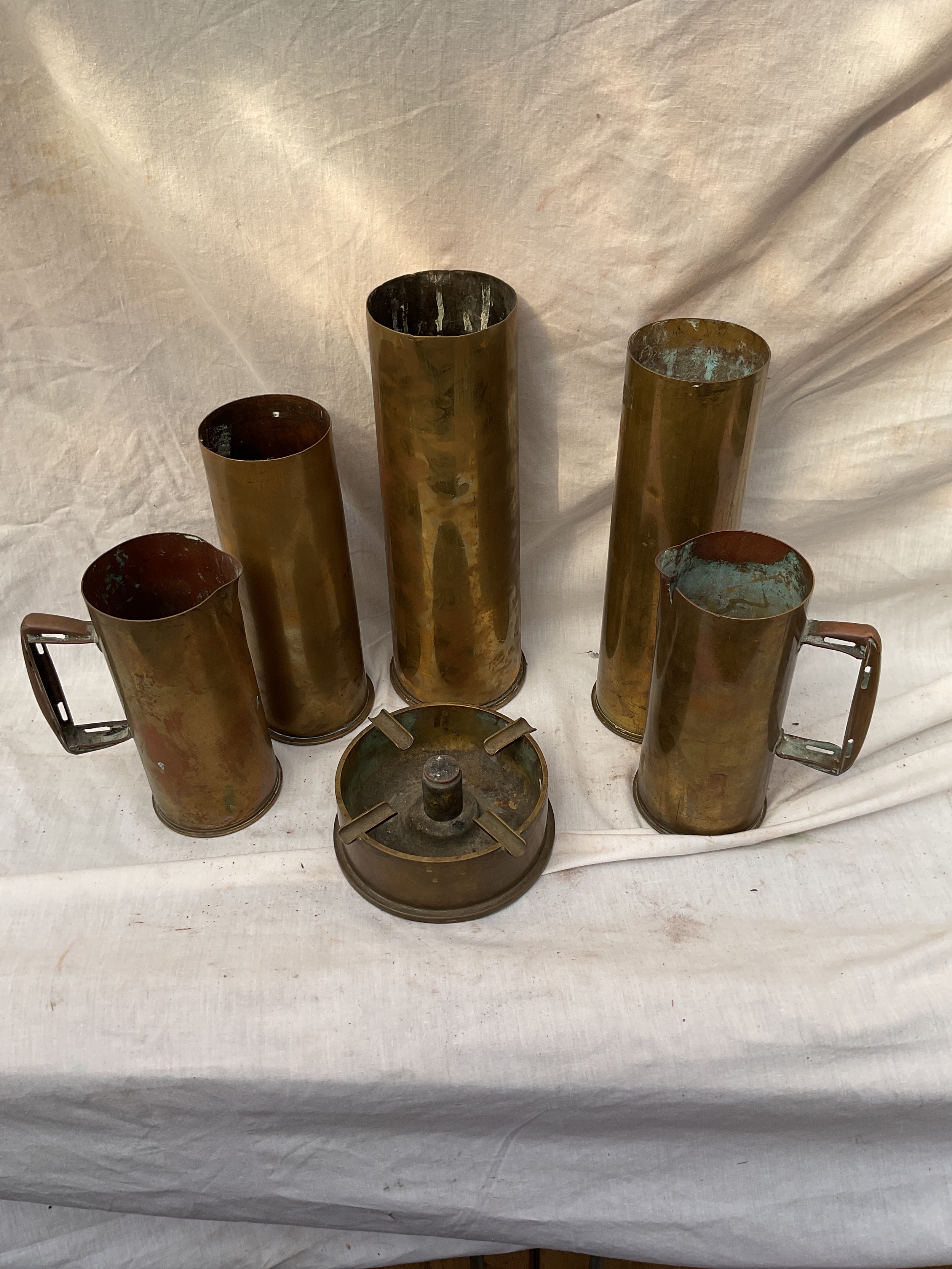 Trench art jugs, ashtray and artillery shells.