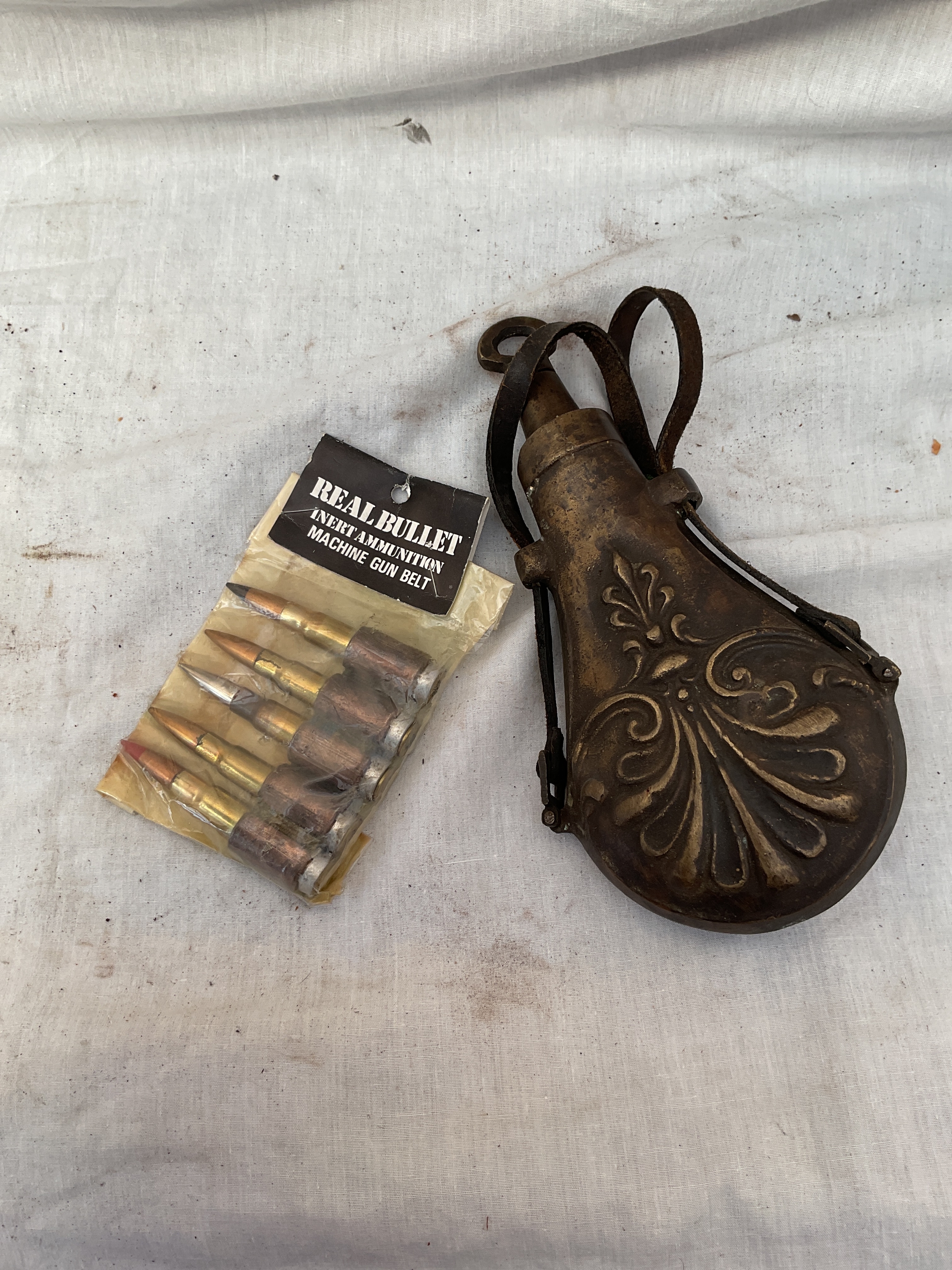 Cast powder flask and inert ammunition.