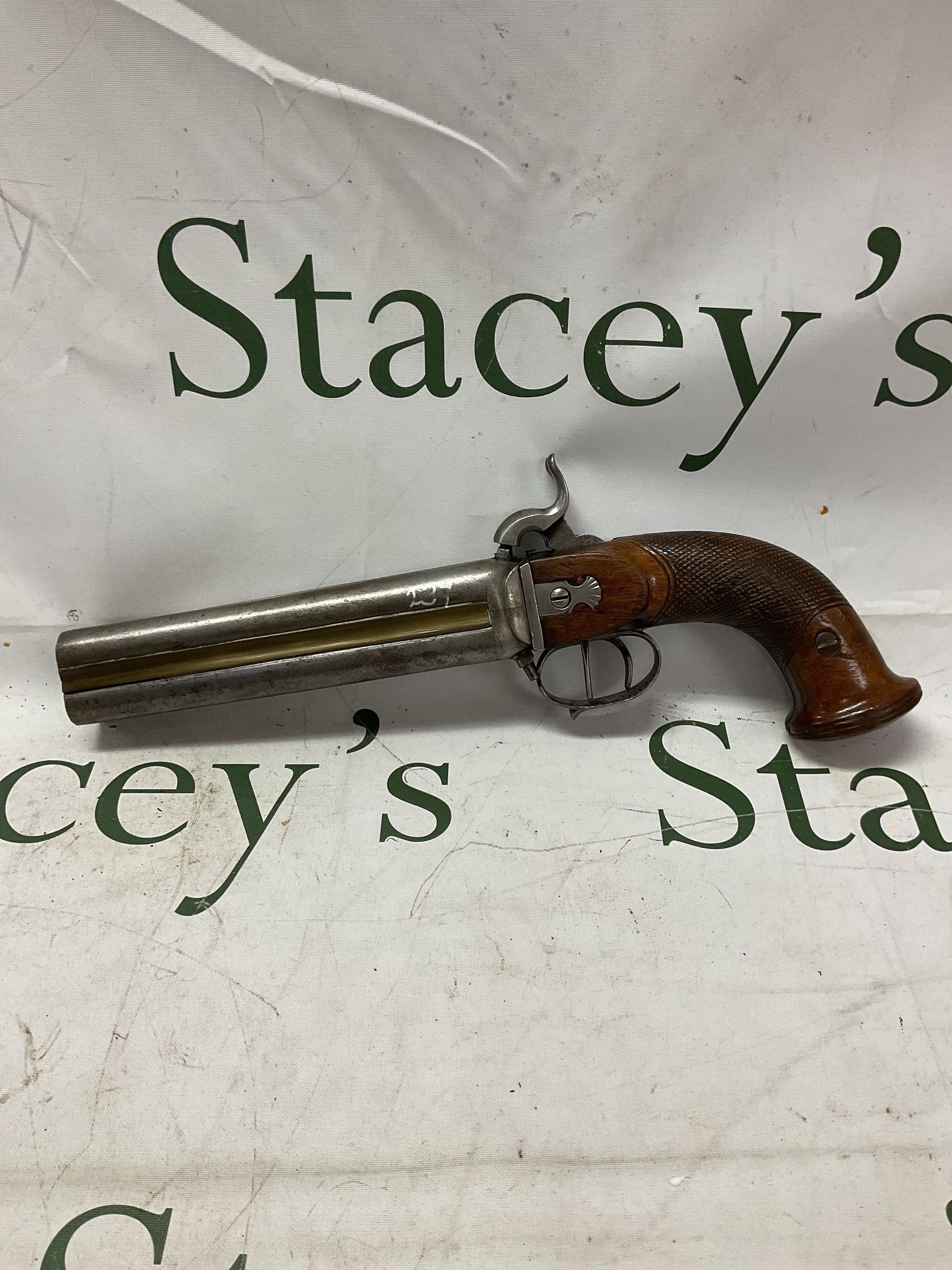 19th c large bore four barrelled turnover percussion pistol, with carved walnut grip and trigger guard reverse action to turn barrels.