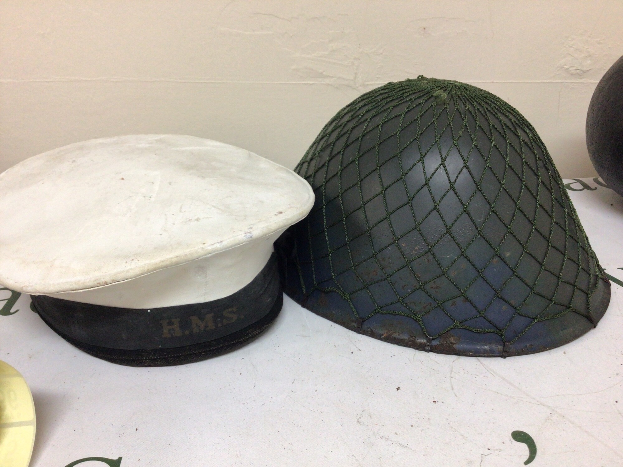 An East German M65 Combat helmet and a British Navy sailors Hat (2)