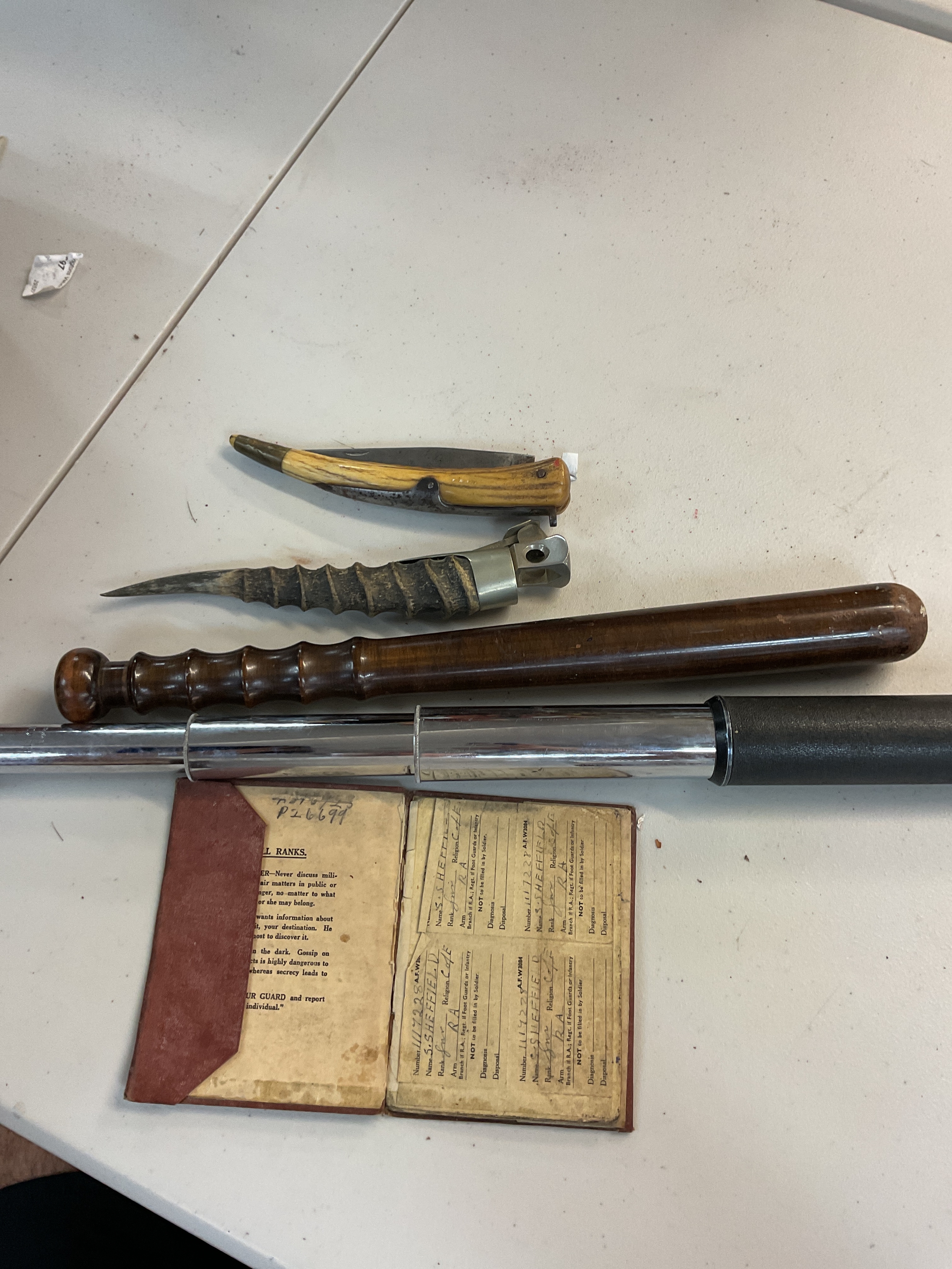A collection of a cigar clipper, a met police truncheon, a telescope, soldiers service and pay book. 