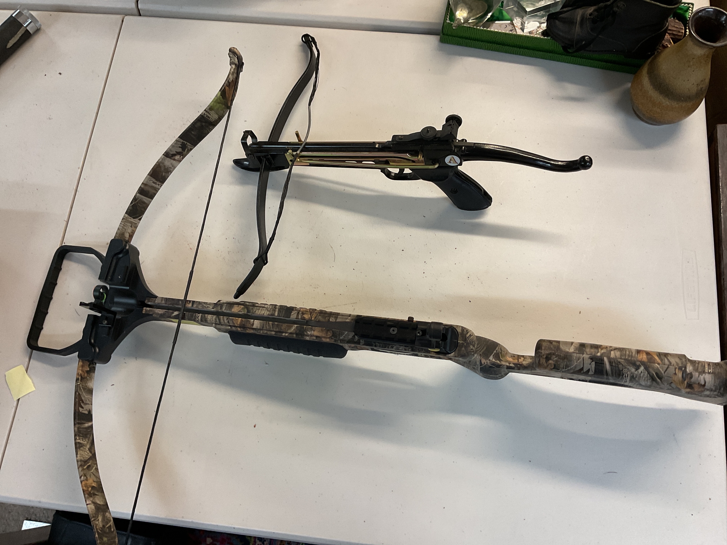 A chase wind recurve crossbow and an additional crossbow, with arrows. 