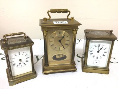 Three brass carriage clocks one for restoration no hour hands on subsidiary dial an enamel dialled carriage clock with key seen working and a modern 8day carriage type clock with a visible pendulum. (3)
