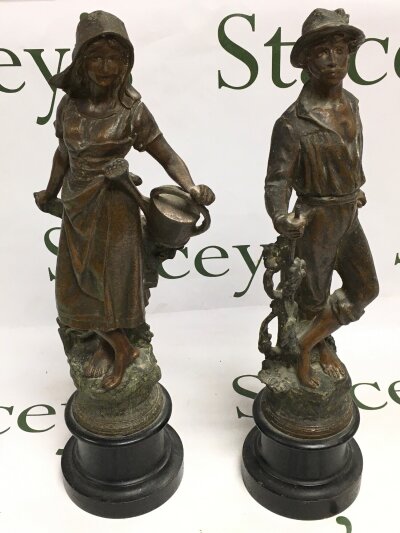A pair of spelter figures, farmer couple. 39cm tall
