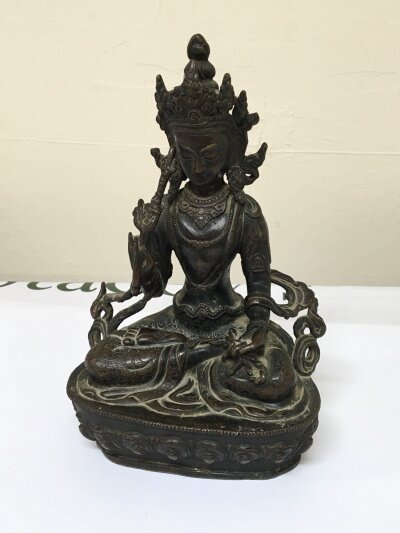 A Cast bronze Tibetan figure of the Goddess White Tara 19th century or earlier with a hollow base. Height 22cm