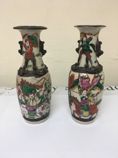 A Pair of late 19th century crackle ware vases decorated with warriors Hight 25cm damaged.