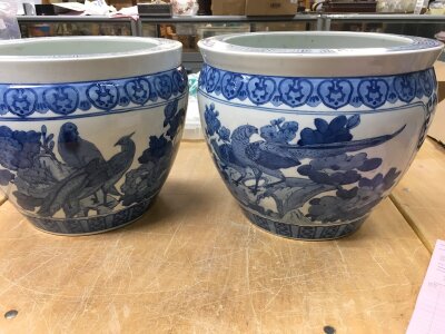 A pair of Chinese style jardinières decorated with birds flowers and foliage.