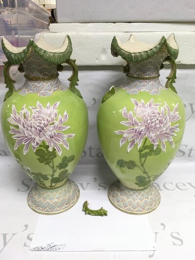 A pair of large late Victorian Japanese vases decorated with flowers on a green ground, one side scroll damaged. Approx height 46cm.- NO RESERVE