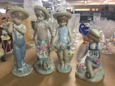 Four Lladro figures children holding flowers .