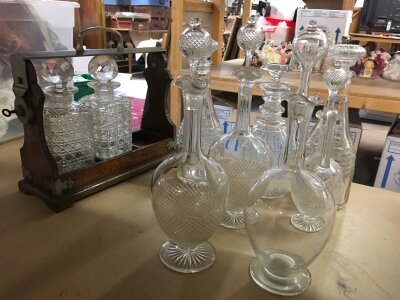 A collection of glass decanters and a oak framed tantalus