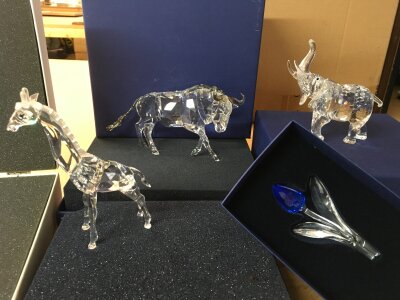 Four boxed Swarovski pieces including bull elephant, giraffe, water buffalo and a rose. No obvious damage or restoration