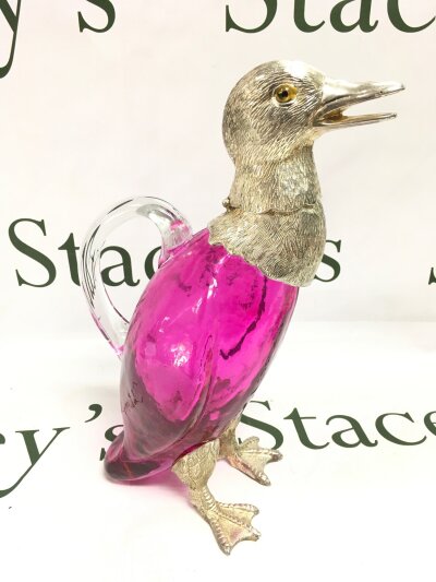 A cranberry duck decanter signed, 27cm tall