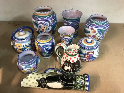 A collection of Poole pottery vases, together with two glazed jugs decorated with cats