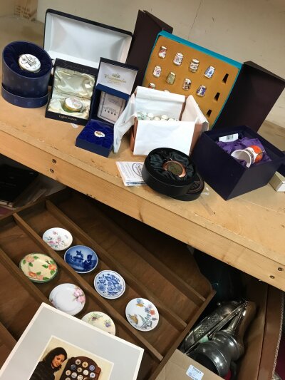 A large collection of various ceramic decorative pieces including Halcyon days enamel pill boxes, thimbles, miniature plates and display wall stand