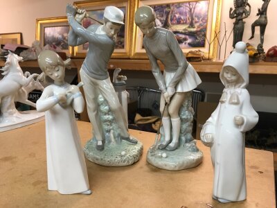 Four Lladro figures including two large golfers