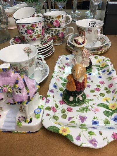 A Sadlers old Chintz tea set (five cups) Two Royal Doulton Bramble hedge figures a Coalport cottage and other cups and sauces.