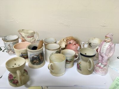 A Collection of ceramics Shaving mugs a bisque dolls head Victorian cups and other associated ceramics.