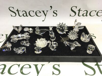 A collection of Swarovski ornaments of animals.