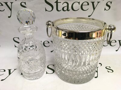 A cut glass ice bucket and a decanter.