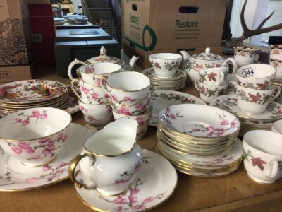 A collection of tea sets comprising Royal Crown Derby plates olde Avesbury pattern Adderley Chinese blossom tea set Wedgwood Ivy House and one other early 20th century tea set.