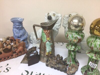 A pair of Staffordshire dogs a pair of glass vases carved soapstone carvings.