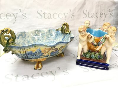 A large Italian Maiolica ceramic centre piece with serpent-form handles, hand painted cherub scene (45cm wide, 15cm tall) and a Majolica cherub centrepiece (22cm tall, 29cm long)