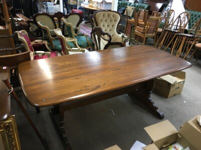 An Ercol table with six swan back chairs (100cm tall 66cm wide)  , table dimensions 178cm wide 75cm tall