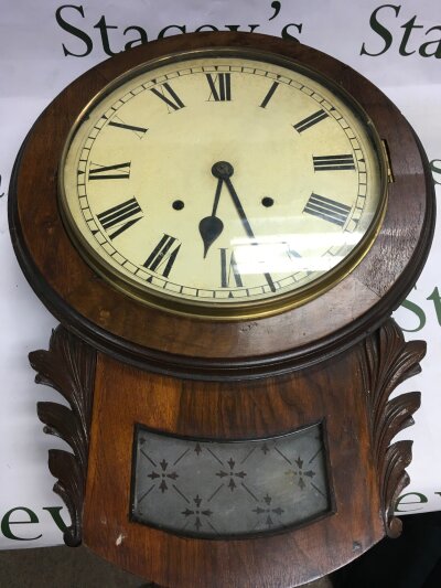 An antique drop dial wall clock.