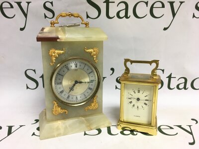 Two carriage clocks comprising a brass cased H Samuel example and one other marble example.
