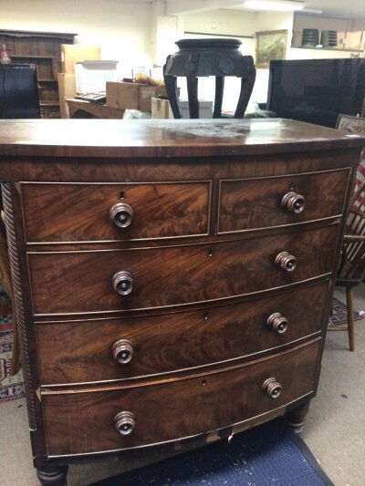 A Victorian mahogany bow fronted chest of drawers fitted with two short and three long drawers on turned feet. 105cm wide 54cm deep height 123cm