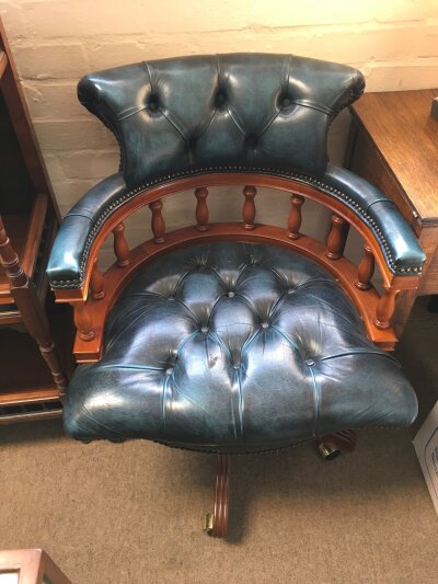 A Captain's style swivel office chair, featuring deep-buttoned teal leather upholstery and a solid wood frame. 65cm wide 80cm tall 58cm long