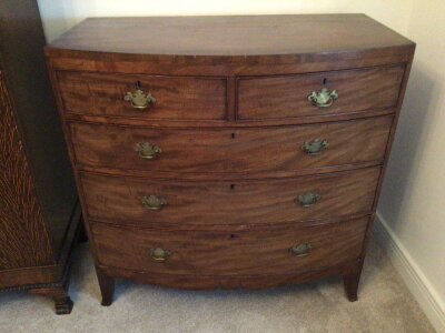 A late George III mahogany bow fronted chest of drawers fitted with two short and three long drawers on swept bracket feet. Width 103cm