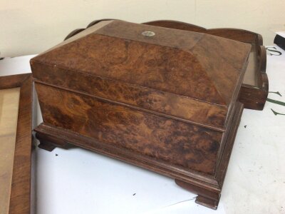 A burr walnut casket with a shaped top a Rosewood box mahogany tray and parquetry panel depicting a church. (4)