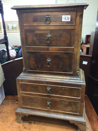 A small walnut cabinet flight of drawers with graduating five drawers on bracket feet. Hight 73cm