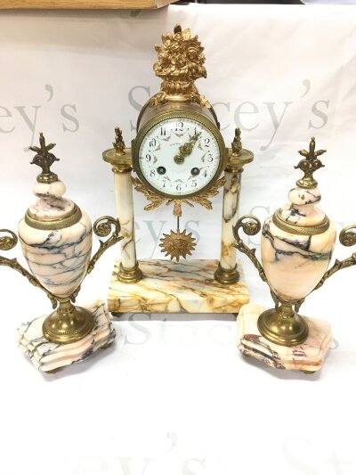 A French pink marble clock with garniture. 28 and 37cm tall