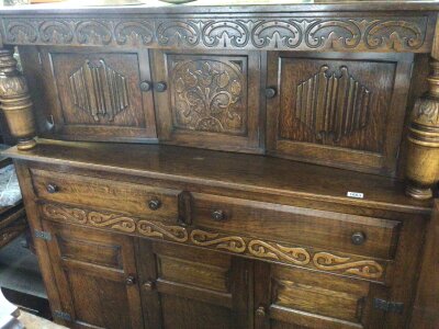 An oak court cupboard with carved supports above drawers and cupboards. Good condition length 141cm 144cm high