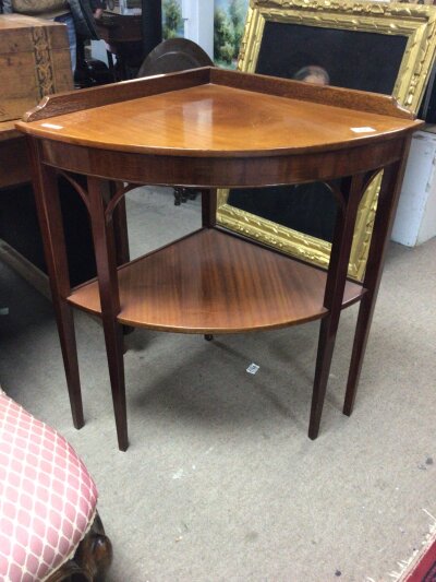 A mahogany occasional corner display table.with four square tapering legs and ope under tier.