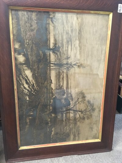 An oak framed print of a countryside view 'a wet roadside'