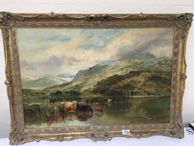 A gilt framed oil painting on canvas study of Highland Cattle at the edge of a Lock with mountains beyond. Signed lower right W Stafford. 88cm x 61cm