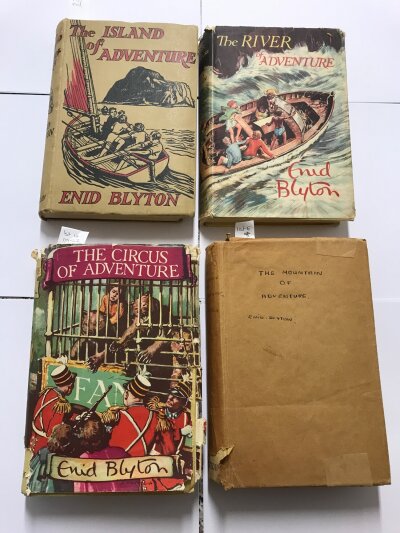 A box containing Twenty Four Enid Blyton Books including Four First Editions published b MacMillan - The Island of Adventure, The Mountain of Adventure, The Circus of Adventure and The River of Adventure. Together with others published by aThe Thames Publishing company