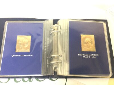 An Album containing a limited edition of 23carat gold stamps The 60th Birthday of Her Majesty Queen Elizabeth II. Thick gold leaf stamps.