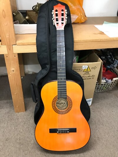 A Palma classical style acoustic guitar, with a soft case