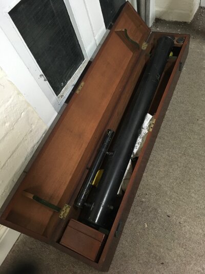 A telescope with lenses, fitted in a mahogany case with stand