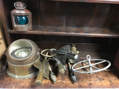 A collection of nautical items including compass, three spinners and a starboard lamp
