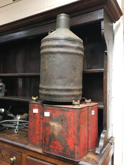 A collection of four oil cans