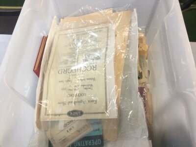 A plastic container various items of railway paperwork