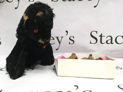 Small vintage teddy bear with glass eyes and four other small bears and old black dog