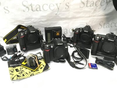 Four Nikon cameras , D3200, D70, D5300 and D80. With battery packs and manuals