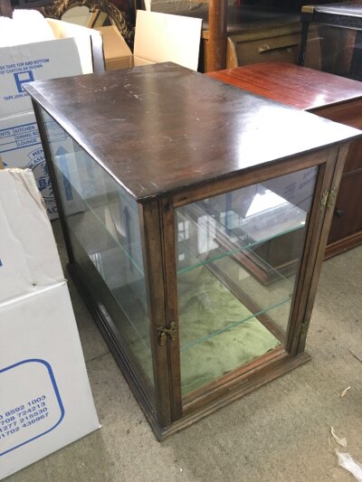 A display cabinet with two glass shelves. 58cm long 45cm tall